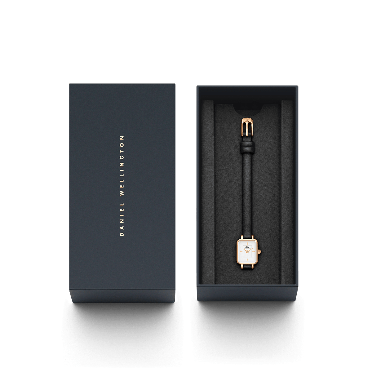 The Quadro Mini Sheffield Rose Gold women's watch with a rectangular case and black leather strap lies elegantly in a black Daniel Wellington gift box.
