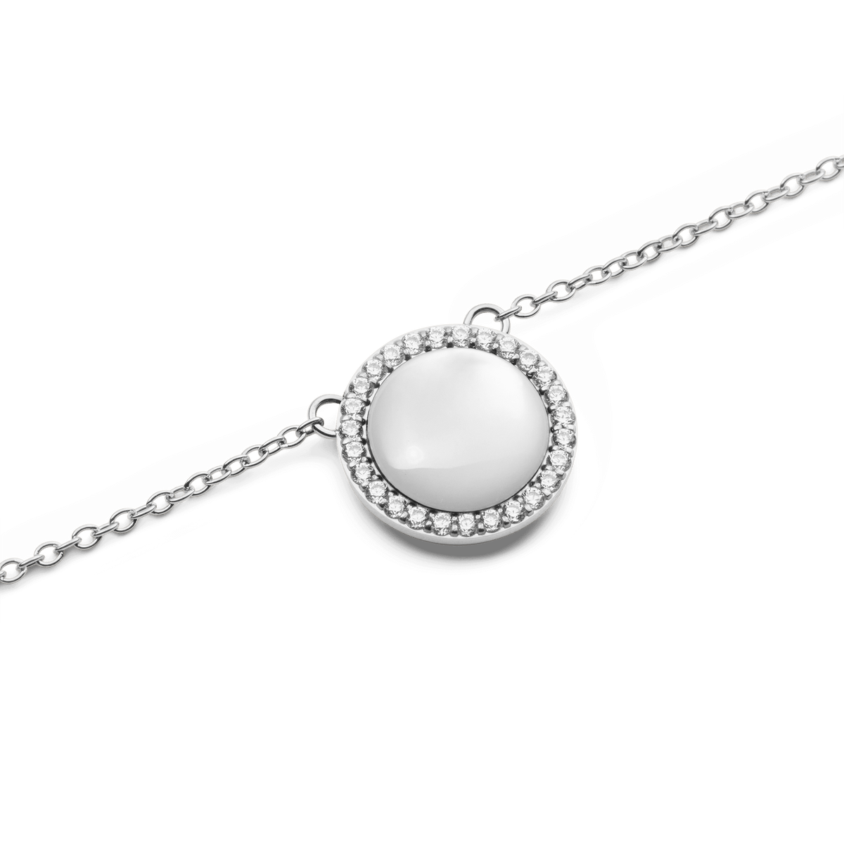 Close-up view of the Audrey necklace in silver with a round mother-of-pearl pendant, surrounded by a delicate row of sparkling cubic zirconia crystals.
