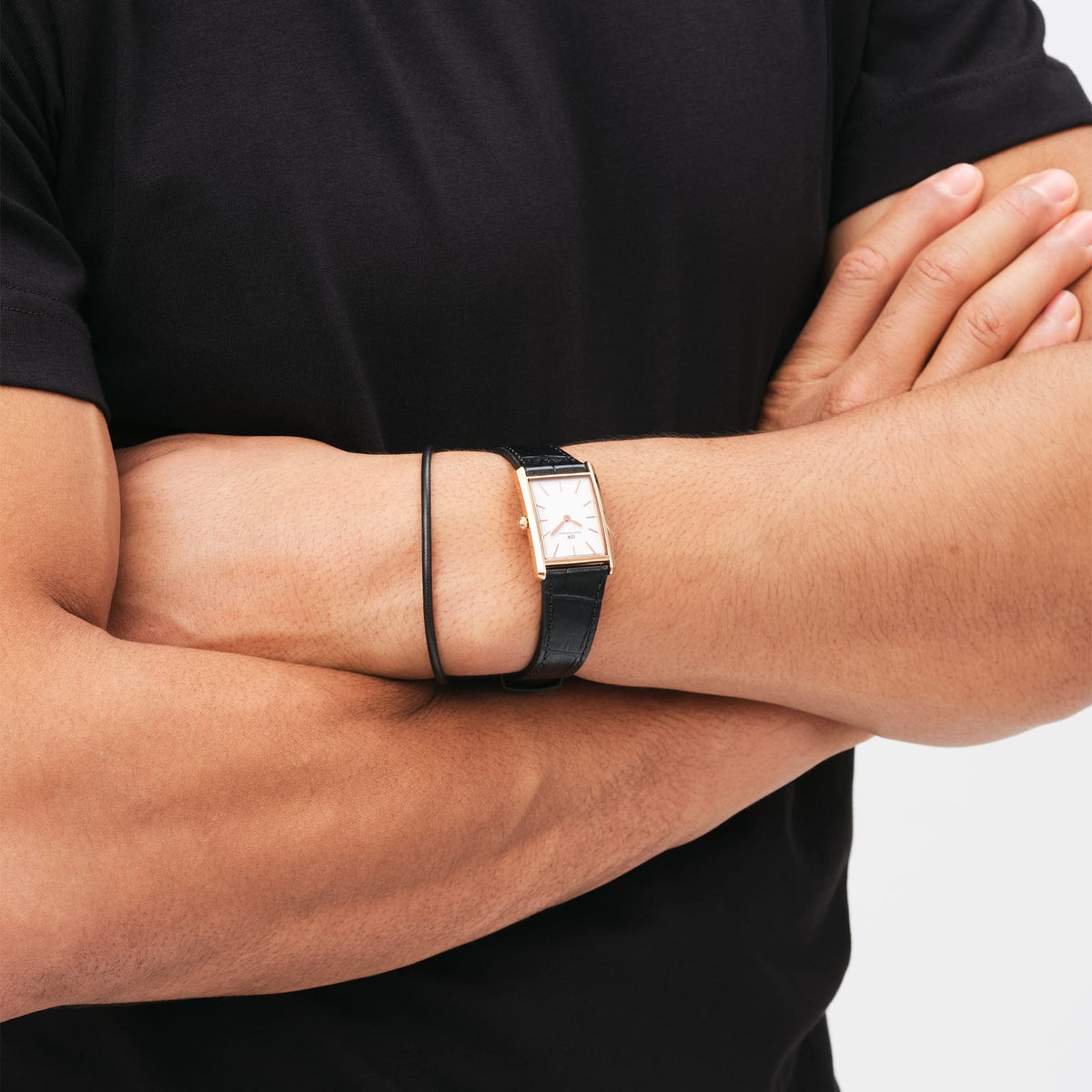 Rectangular Bound Black Crocodile Rose Gold ladies' watch with black leather strap and rose gold case, worn on the wrist with a black T-shirt.