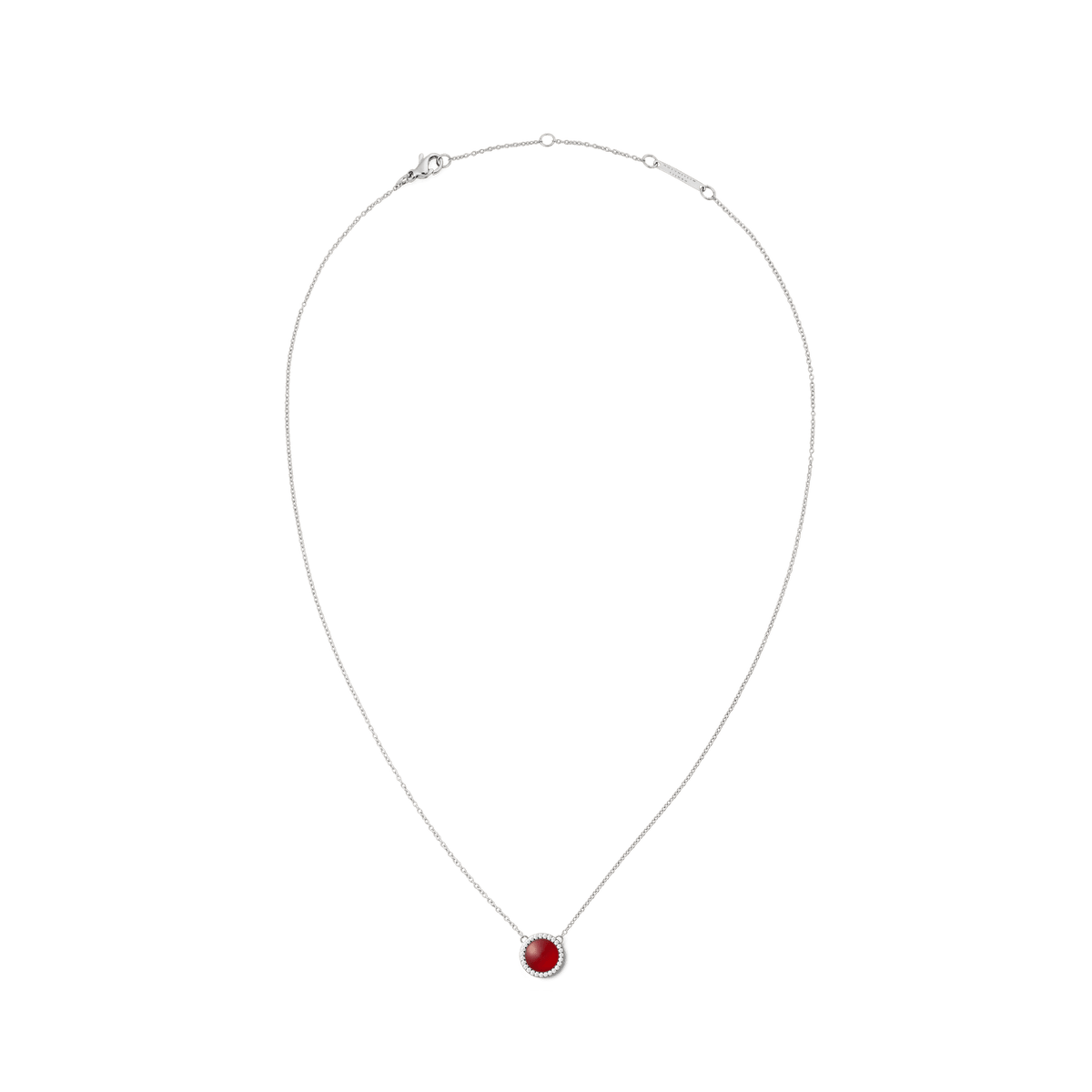 Delicate silver chain with a round red agate pendant, framed by white zirconia crystals, against a white background.