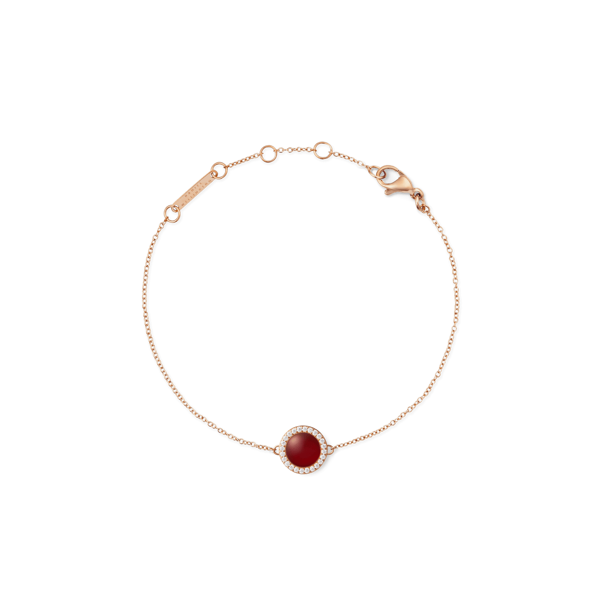 Delicate bracelet made of rose gold with a round red agate pendant, surrounded by white zirconia crystals, on a fine chain with a lobster clasp.