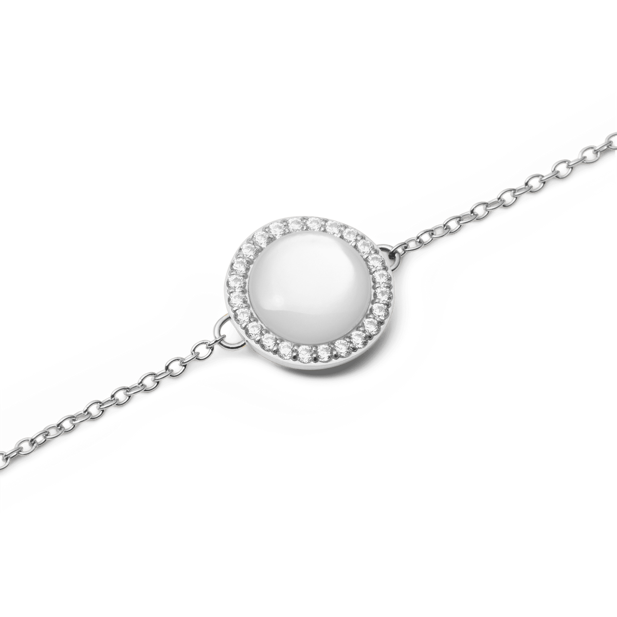 Close-up view of the silver Audrey Bracelet with a round mother-of-pearl pendant, surrounded by a delicate row of white cubic zirconia crystals.