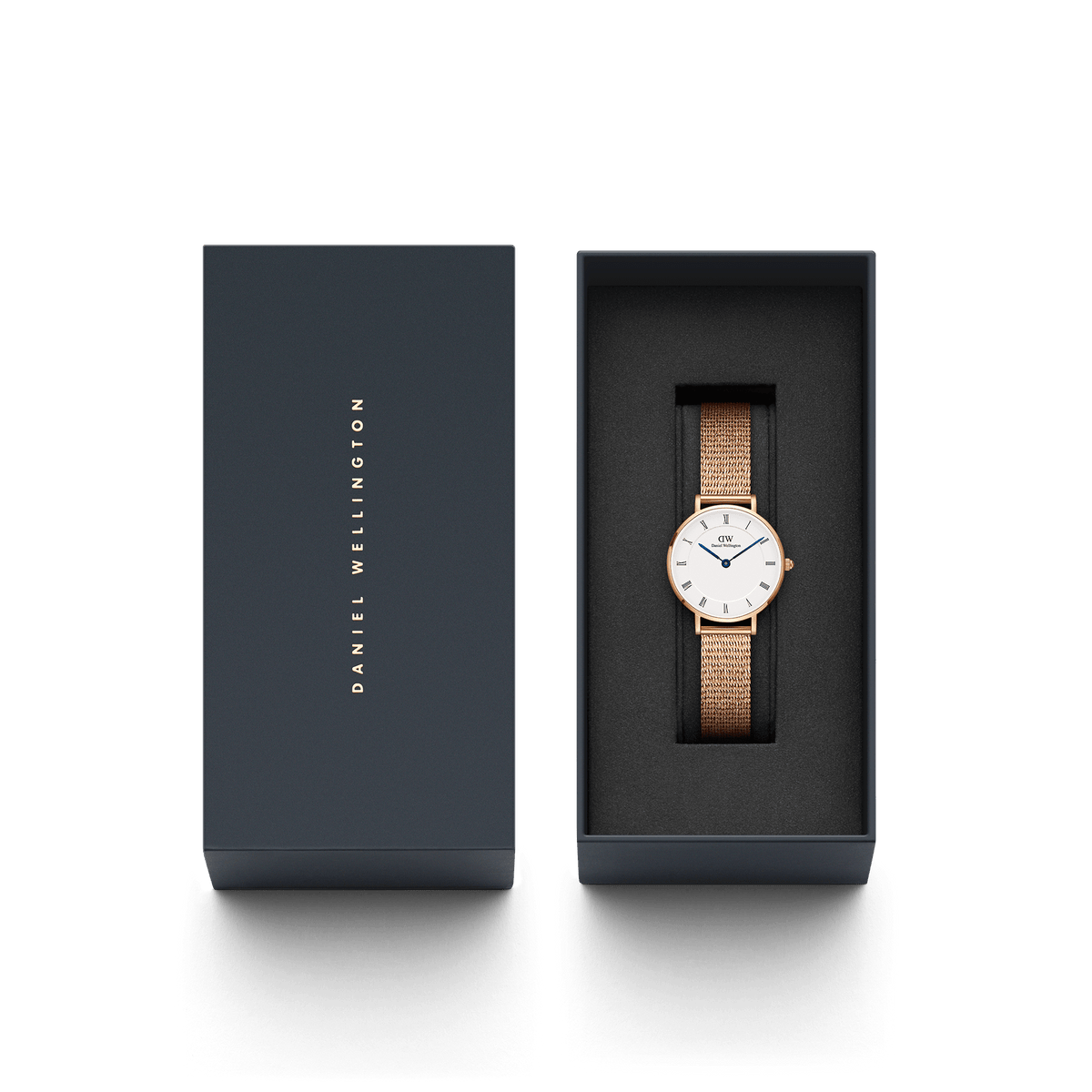 The Petite Roman Numerals Melrose women's watch in rose gold with mesh strap is presented in an elegant dark blue gift box.