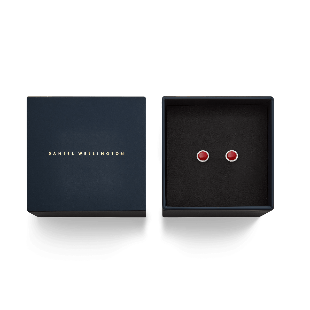 Audrey stud earrings with red agate and a silver zirconia border in an elegant dark blue Daniel Wellington gift box.