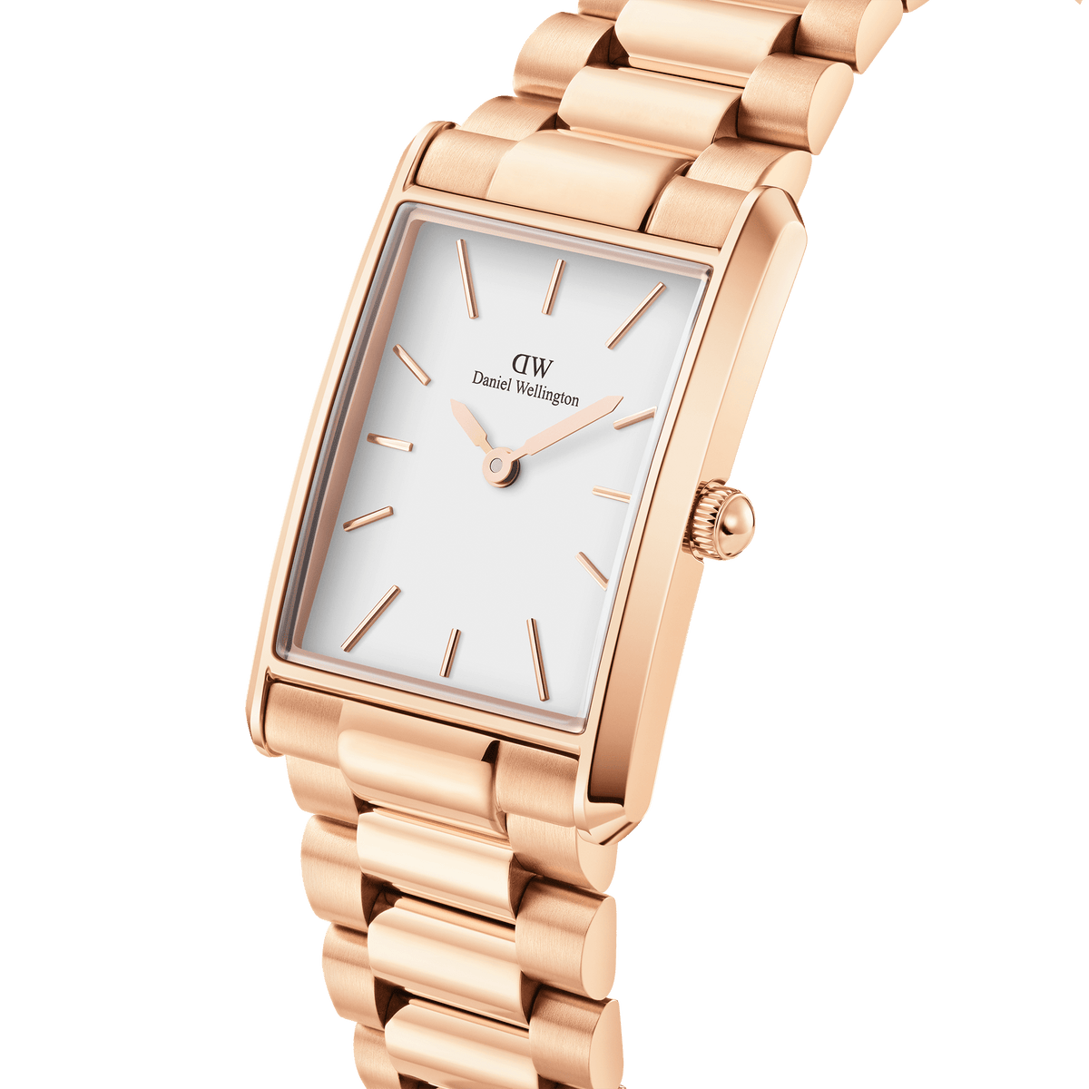 Close-up view of the Bound 3-Link Rose Gold women's watch by Daniel Wellington with a rectangular case, white dial and polished 3-link rose gold bracelet.