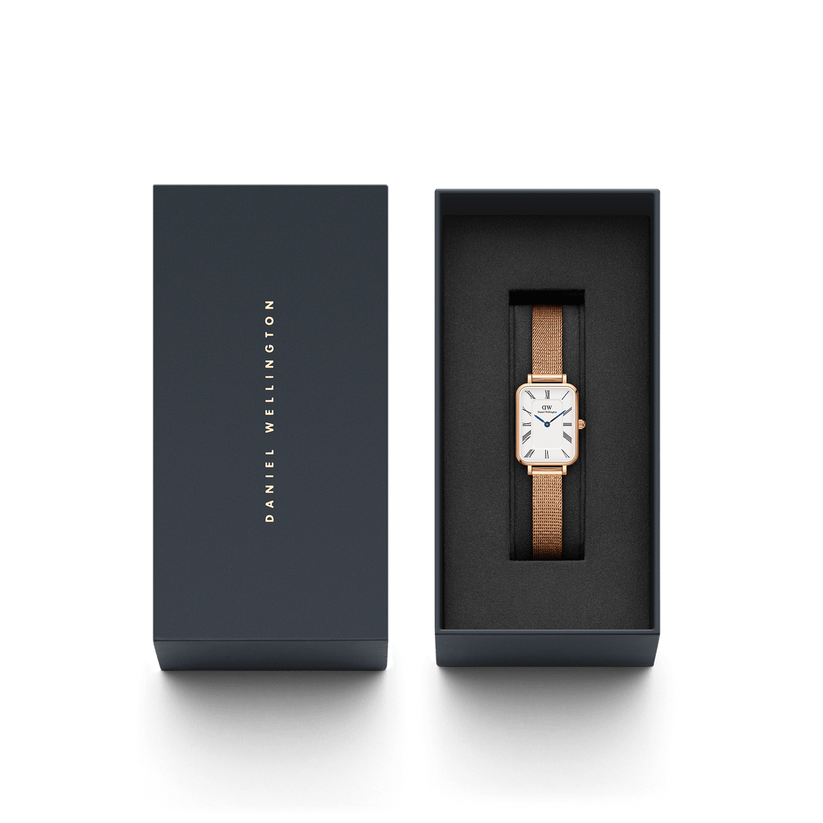 The Quadro Roman Numerals Melrose ladies' watch with a rectangular rose gold case and mesh strap is elegantly presented in a black Daniel Wellington gift box.