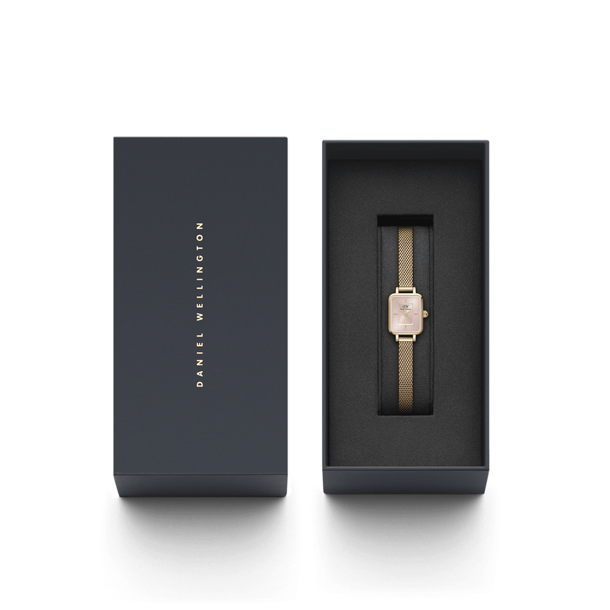 The Quadro Mini Evergold Blush women's watch with a gold-coloured mesh strap and rose-coloured dial is elegantly presented in a black Daniel Wellington gift box.