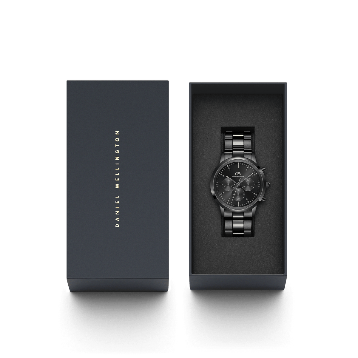 The Iconic Chronograph Link Onyx B lies elegantly in a black Daniel Wellington gift box with gold lettering.