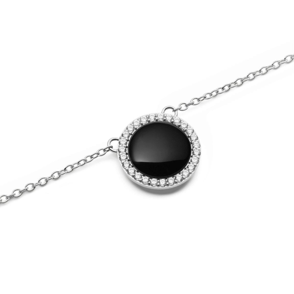 Close-up view of the round pendant of the Audrey Necklace Black Agate Silver, featuring glossy black agate and a sparkling zirconia crystal border on a delicate silver chain.