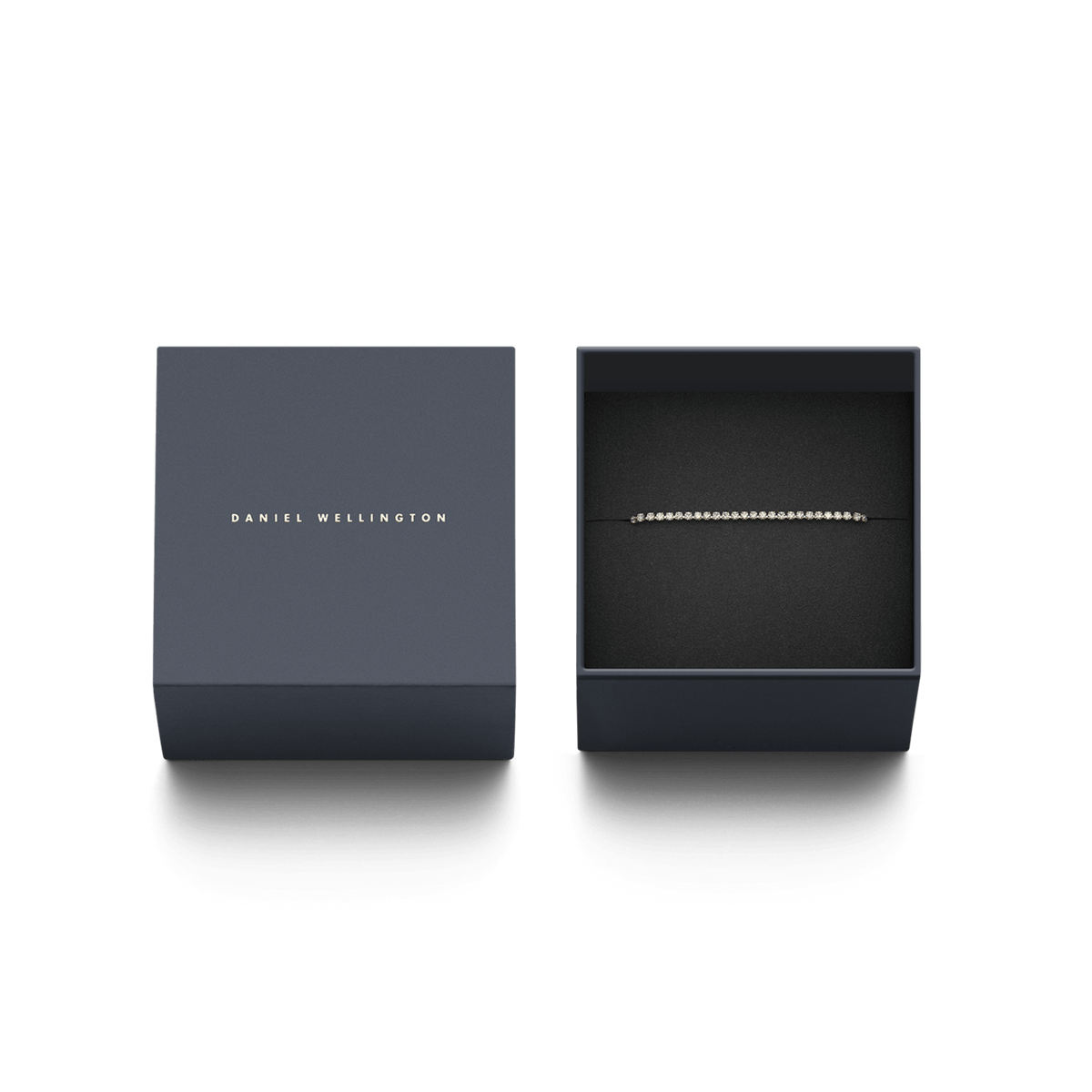 The Classic Tennis Bracelet Gold by Daniel Wellington is elegantly presented in a sophisticated dark blue gift box with gold embossing.
