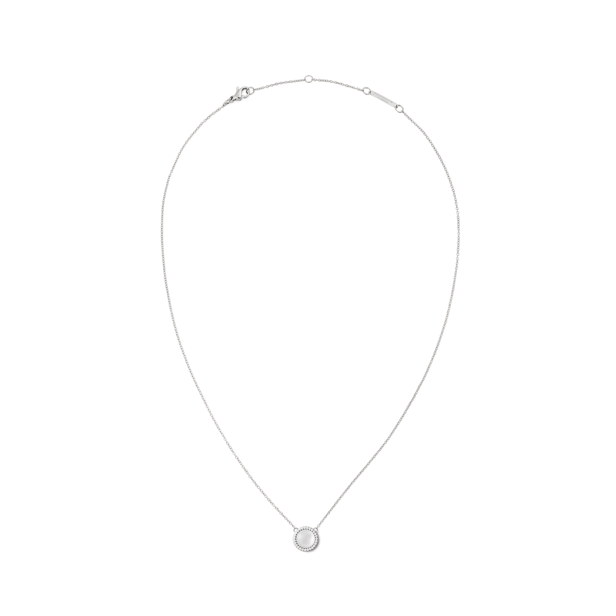 Delicate silver necklace with a round mother-of-pearl pendant, framed by white cubic zirconia crystals, in a minimalist design.