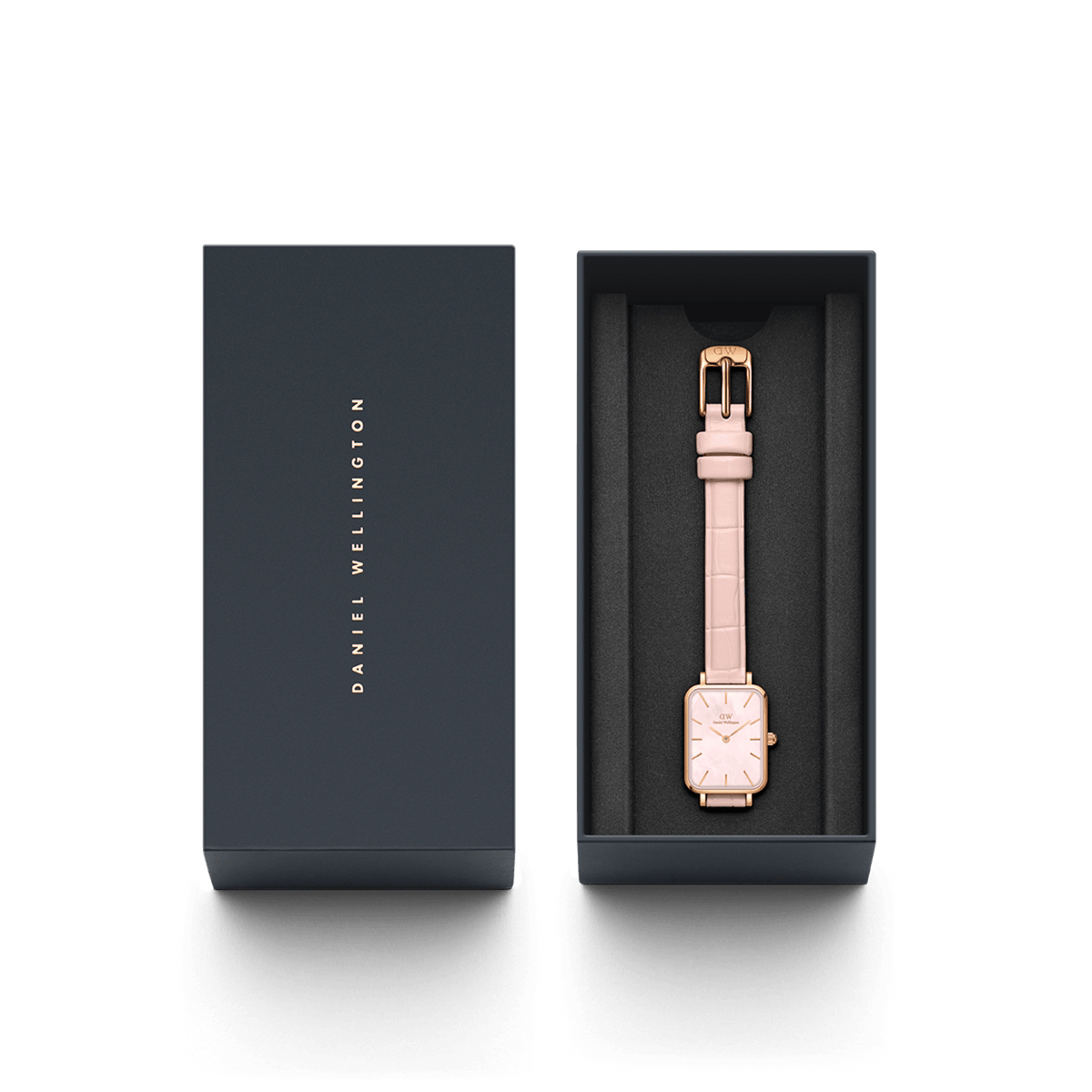 The Quadro Pressed Rouge ladies' watch with a rectangular case, rose gold stainless steel, and a nude-pink leather strap is elegantly presented in a black Daniel Wellington gift box.