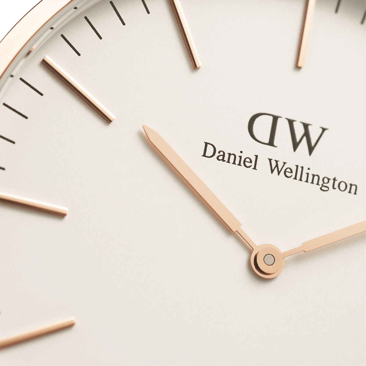 Macro shot of the eggshell white dial of the Daniel Wellington Classic Bristol with rose gold hands and indices.