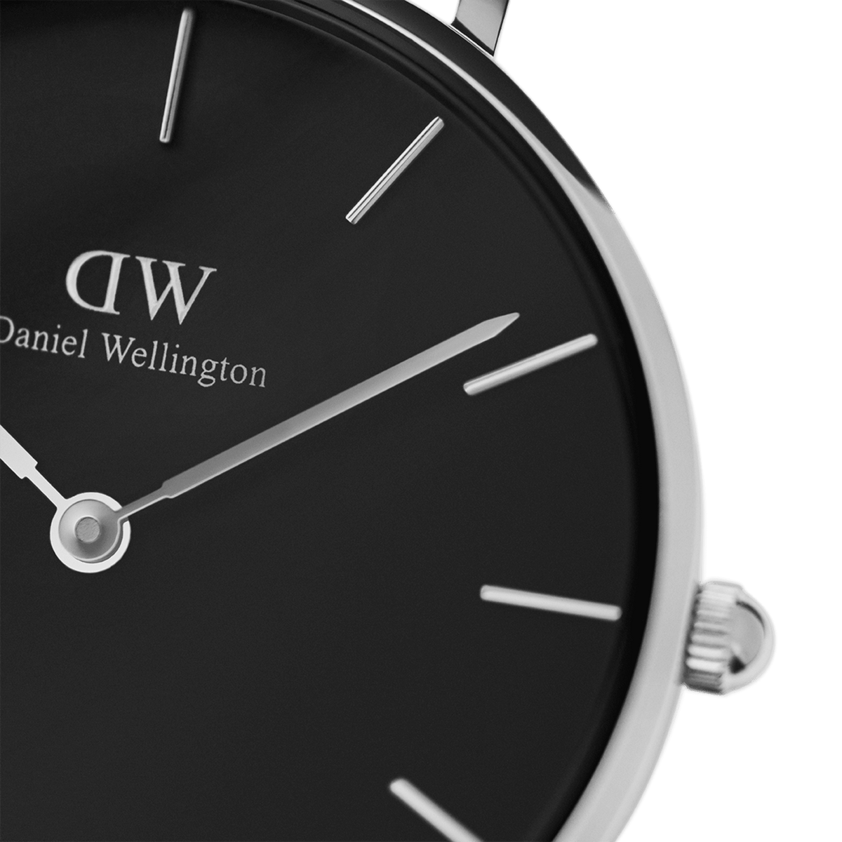 Dettaglio del quadrante nero dell'orologio **Petite York** con logo **Daniel Wellington**, indici minimalisti in argento, lancette sottili e corona laterale zigrinata in acciaio inossidabile.