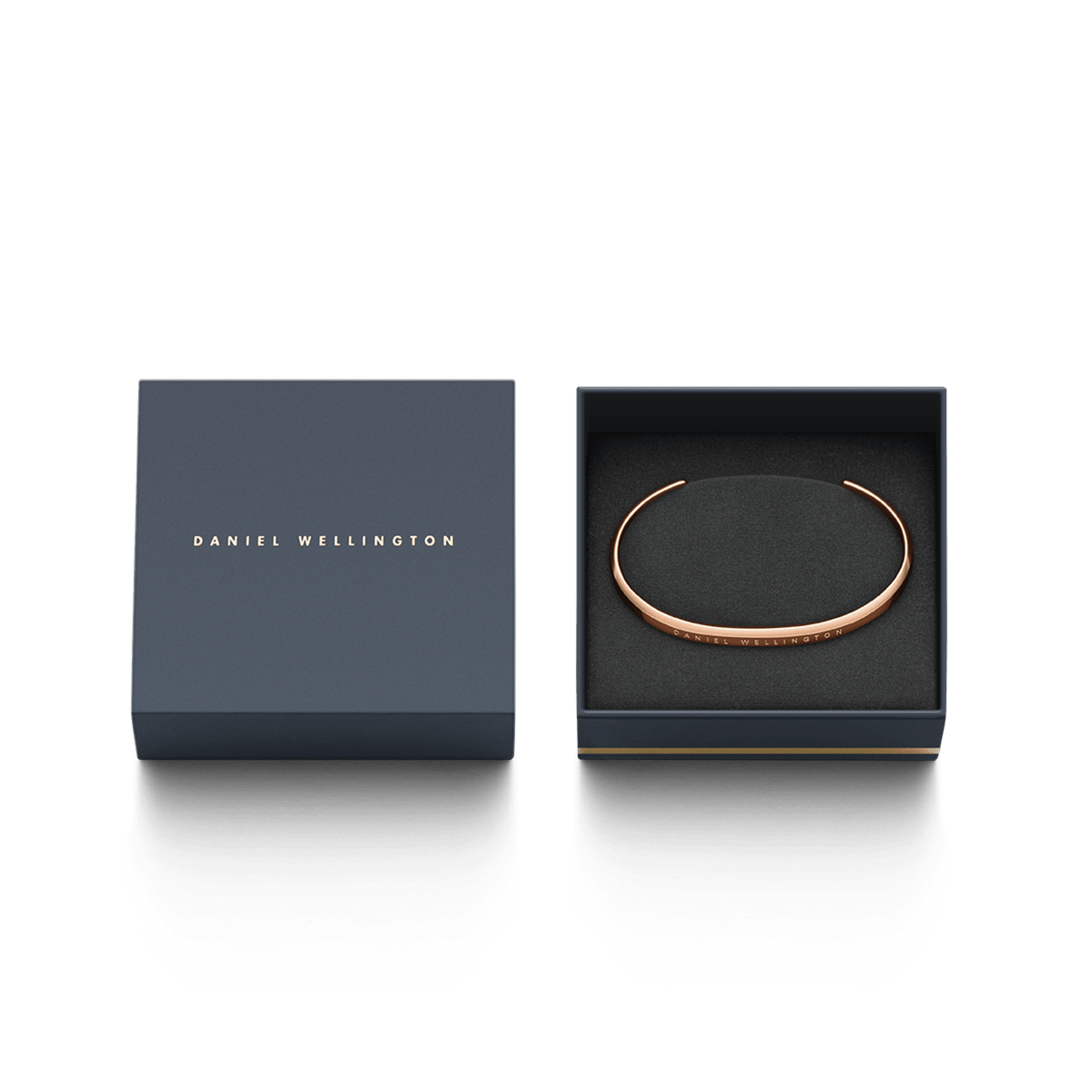 The Classic Bracelet in rose gold by Daniel Wellington rests elegantly in a sophisticated dark blue gift box with gold embossing.