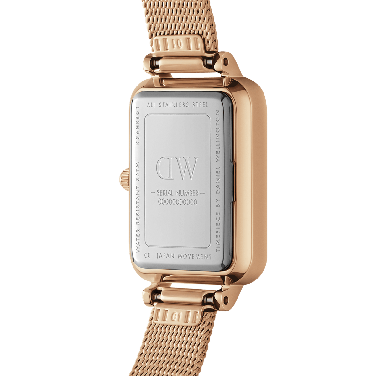 Back view of the Quadro Pressed Melrose Emerald women's watch with engraved stainless steel case back, serial number, and rose gold mesh strap.
