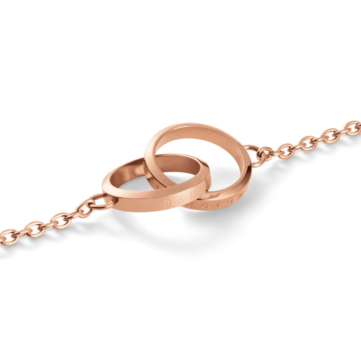 Close-up view of the Elan Unity necklace in rose gold with two interlinked, engraved rings on a fine link chain.