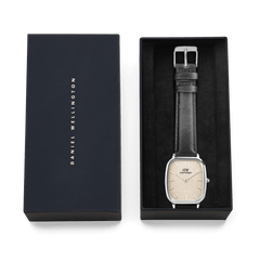 Marlon Sheffield Linen Silver watch with a square silver case and black leather strap in an elegant Daniel Wellington gift box.