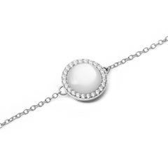 Close-up view of the silver Audrey Bracelet with a round mother-of-pearl pendant, surrounded by a delicate row of white cubic zirconia crystals.