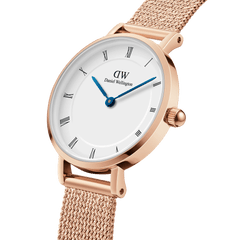 Detailed view of the Petite Roman Numerals Melrose women's watch with a rose gold stainless steel case, white dial, Roman numerals and fine blue hands.