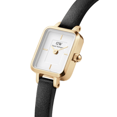 Close-up view of the Quadro Mini Sheffield Gold women's watch with a rectangular, gold-coloured case, white dial, and black leather strap.