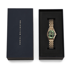 The Daniel Wellington Ophelia Mini Emerald Gold with a gold-coloured stainless steel bracelet and green dial is elegantly presented in a black gift box.