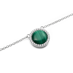 Close-up view of the round pendant of the Audrey Malachite Silver Necklace with green malachite and a sparkling zirconia border on a delicate silver chain.